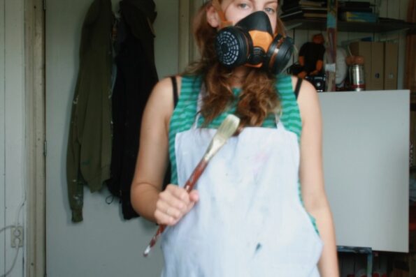 Motherhood and Artistic Practice - Girl with mask holding a paintbrush